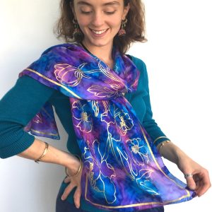Hand-painted-long-silk-scarf-in vibrant-blue-with-gold-flower-design